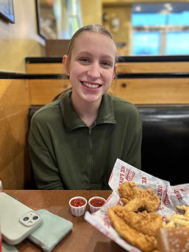 Girl smiling while eating Raising Canes