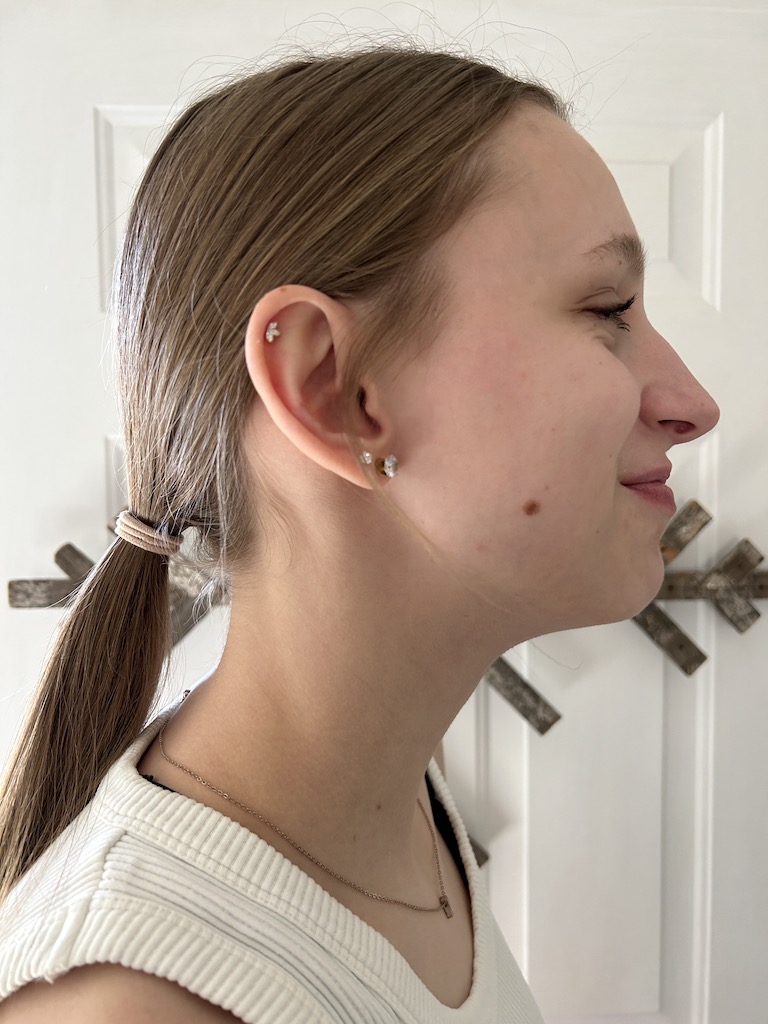 Girl showing off ear piercing