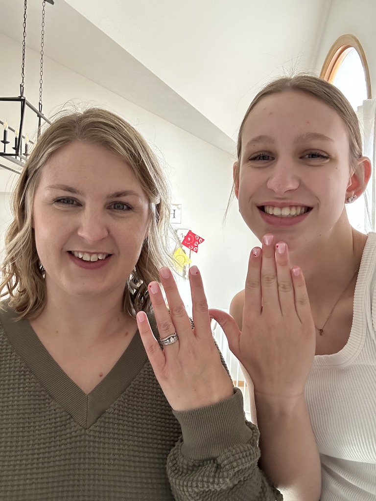 Mom and daughter showing off new nails