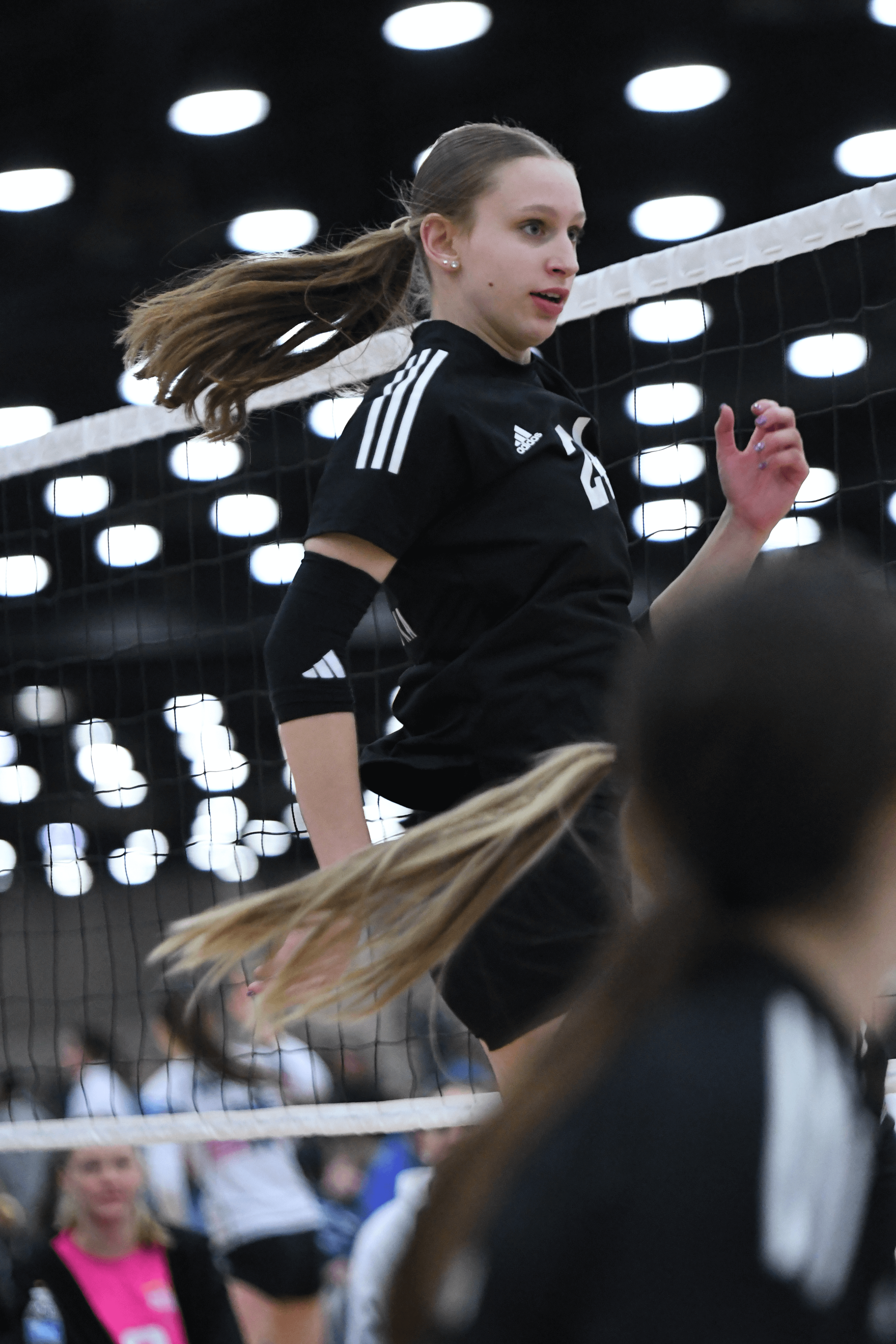 Volleyball player above the net going for an attack